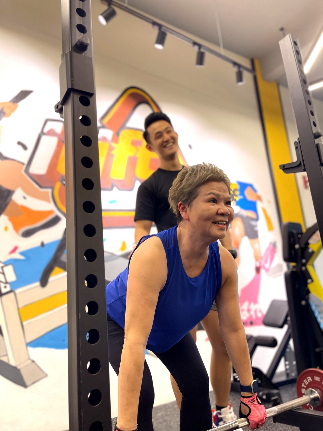 An iLift coach guiding an older client through a lift in Kuching
