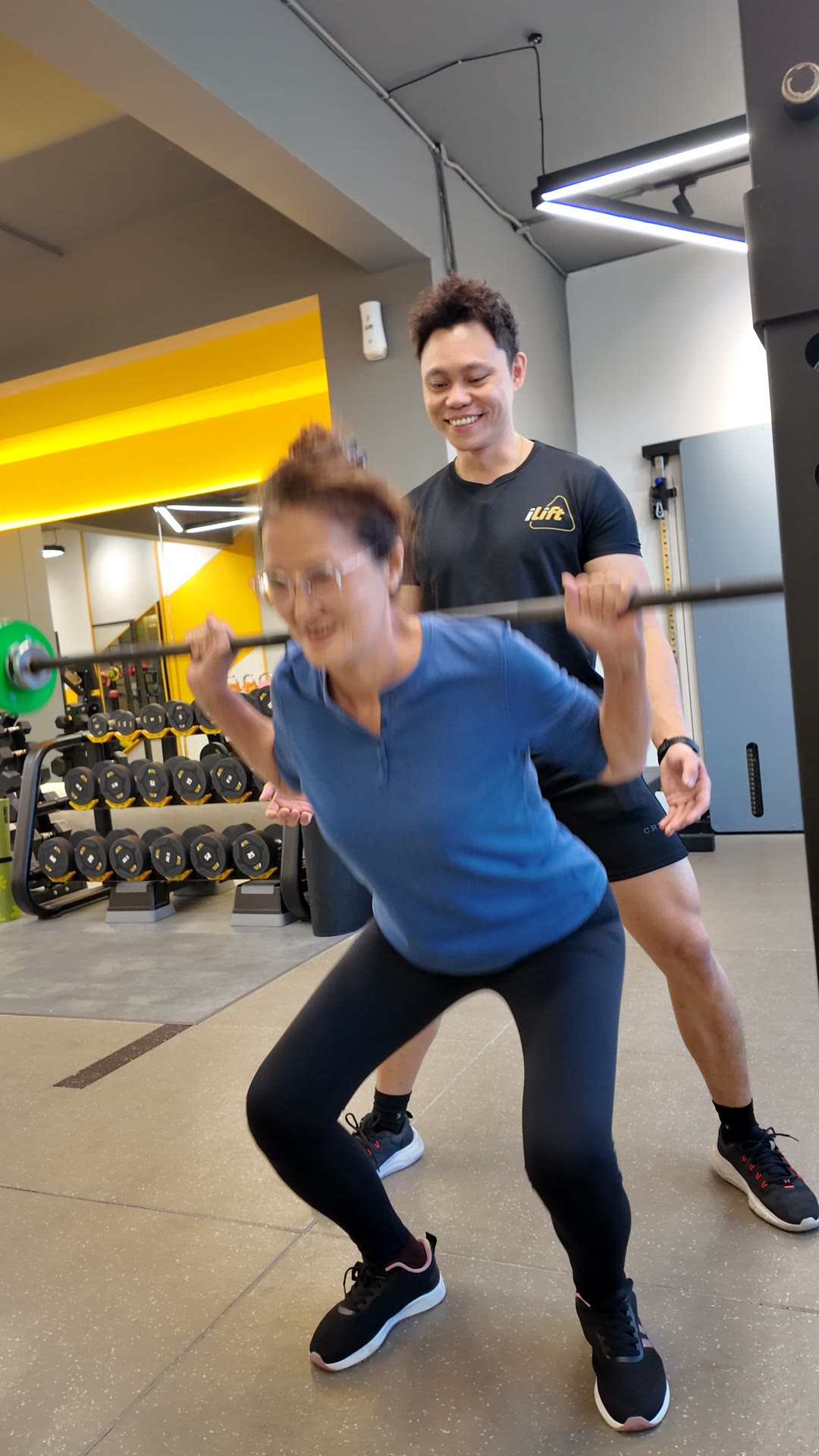 A woman in her 60s with a history of knee pain squatting with her iLift coach