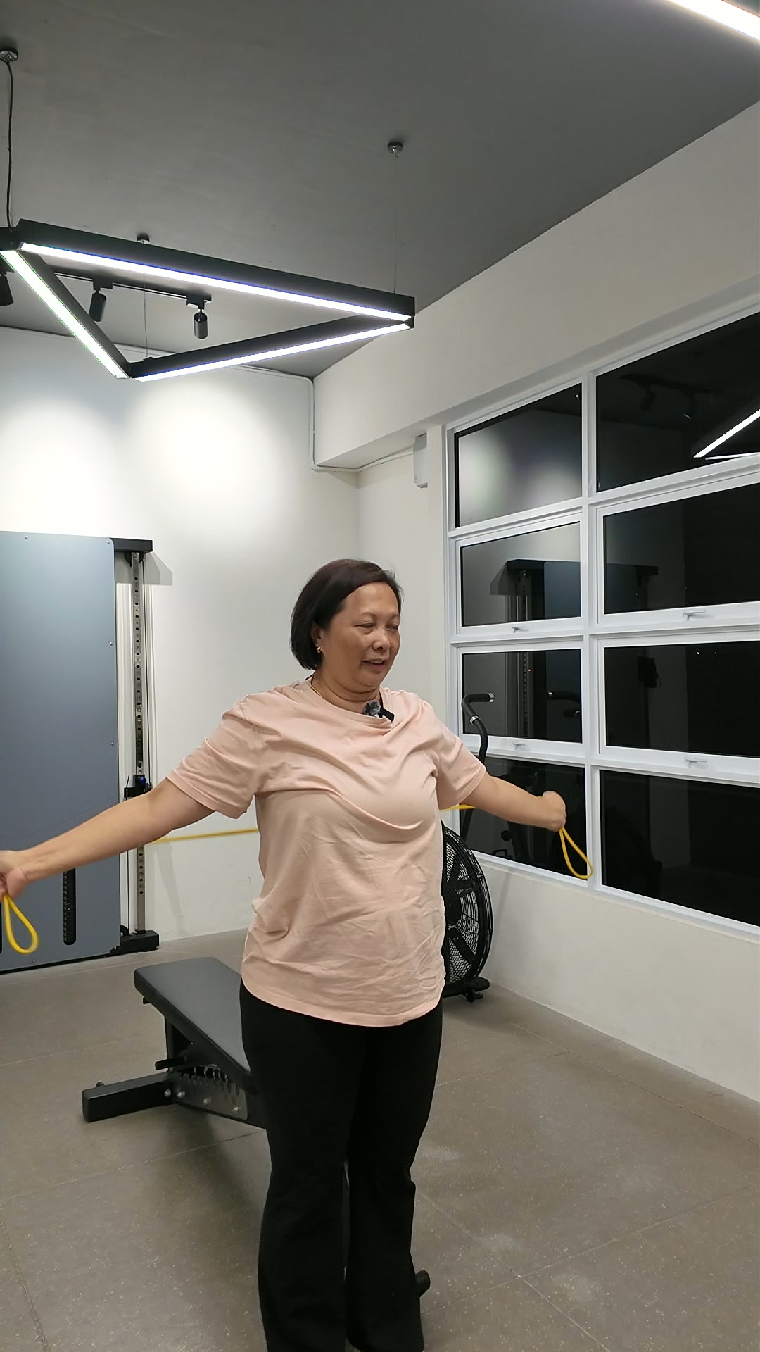 Phyllis doing a band pull-apart exercise at iLift Pines Square